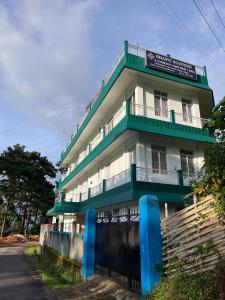 a tall building with green and white at Shanti Sojourn in Shillong