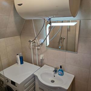 a small bathroom with a sink and a mirror at Bosaca in Žabljak +23 photos