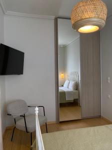 a room with a mirror and a bedroom with a bed at Casa Di Sabbia Air-bnb in Nafpaktos +10 photos