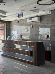 a restaurant with a counter in a room at أعمال الهاشم للشقق المخدومة الوجه Al Hashem for Served Apartments in Al Wajh