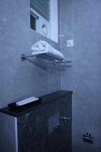 a bathroom with a shower with a towel on a counter at Hotel Nanda Mohan Residency -MSR Manssion Inn in Tirupati +67 photos