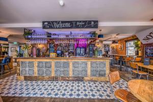 a bar in a restaurant with a counter and chairs at rooms@73 in Waterlooville +22 photos