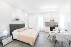 a bedroom with a bed and a table and chairs at Affittacamere SANT'ANNA in Caltagirone