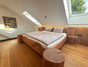 a bedroom with a large wooden bed with a window at Log Garden Estate in Dobrova