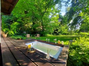 a swimming pool on a deck next to a pond at Staruszka Chata in Sidzina