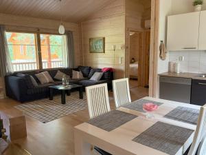 a living room with a couch and a table at Villa Maya, cottage for vacation holidays in Jaala