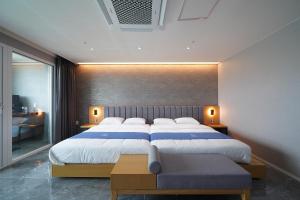 a bedroom with a large bed and a large window at Hotel Opus in Gyeongju +48 photos