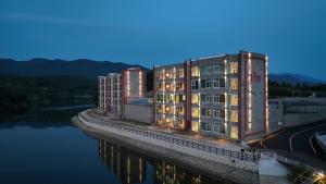 a building next to a body of water at Hotel Opus in Gyeongju