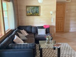 a living room with a blue couch and a table at Villa Maya, cottage for vacation holidays in Jaala