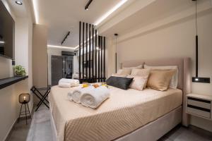 a bedroom with a large bed with towels on it at Monte Smith Luxury Suites in Rhodes Town