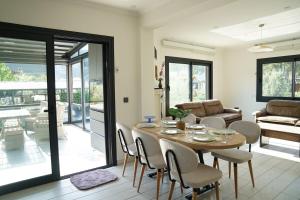 a dining room with a table and chairs at Orange Tree Villa, Happy Tree Houses in Dalaman