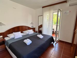 a bedroom with a bed with two towels on it at Guest House Sol 1 in Cavtat +12 photos