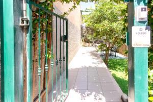 a gate on a sidewalk next to a building at Il Ciliegio - Casa Vacanza Macerata in Macerata