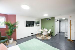 a living room with a table and chairs at Central - Green - Stylish - Quiet Sleep in Debrecen