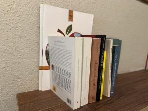 three books sitting on top of a shelf at Φιλυρέα Apartments - Room 2 in Zagora