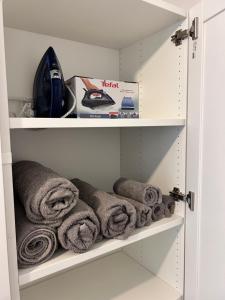 a cupboard with towels on the shelves at Piast Castle Apartment Brzeg in Brzeg
