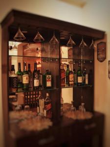 a shelf filled with lots of bottles of alcohol at The Mussoorie Glow in Dehradun