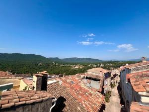 an overhead view of roofs of buildings with mountains in the background at Cosy village Home with Horizon in Bagnols-en-Forêt