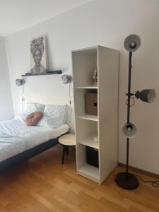 a bedroom with a bed and a book shelf at Le Beau Coin de Paris in Soisy-sous-Montmorency