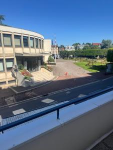 a view of a building and a street from a window at Le Beau Coin de Paris in Soisy-sous-Montmorency
