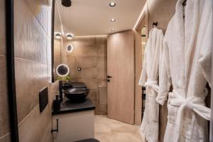 a bathroom with a sink and a mirror at Monte Smith Luxury Suites in Rhodes Town +83 photos