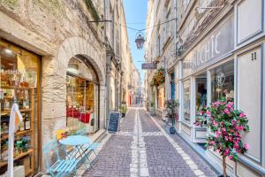 an alley in an old town with shops at L'appartement d'Olympe in Périgueux
