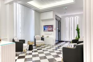 a living room with chairs and a checkered floor at Camelia Prestige - Place de la Nation in Paris