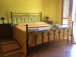 Schlafzimmer mit einem Bett mit Metallrahmen in der Unterkunft Agriturismo La Grotta Del Tesoro in Santadi