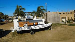 a boat sitting on the ground in front of a building at Puerto San Carlos Bay House & Tours -2nd Floor- in San Carlos
