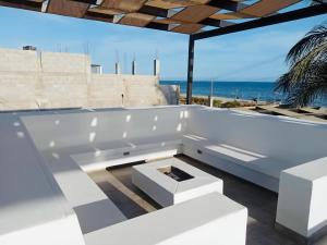 a white tub sitting on top of a building with the ocean at Puerto San Carlos Bay House & Tours -2nd Floor- in San Carlos +16 photos