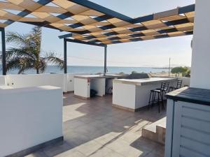 an outdoor kitchen with a view of the ocean at Puerto San Carlos Bay House & Tours -2nd Floor- in San Carlos