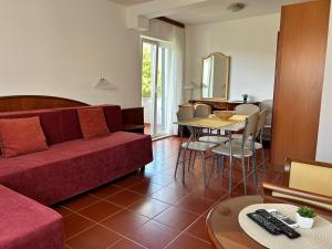 a living room with a couch and a table at Guest House Sol in Cavtat