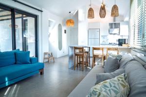 a living room with a couch and a kitchen at Vacation - Honeymoon House in Ortaca