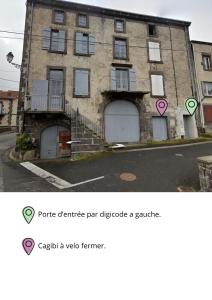 a building with two garage doors on a street at Appartement avec chambre in Volvic
