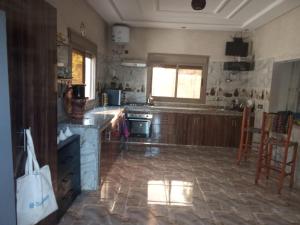 a kitchen with a stove and a counter top at charmante villa à découvrir in Aghmat