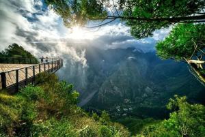 a view of a mountain with people on a viewing deck at Villa Namana - avec piscine et vue mer - Nosy Be in Saint-Denis