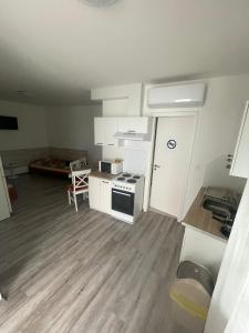 a small kitchen with a stove and a sink at Bem apartmanok Kecskemét in Kecskemét +24 photos