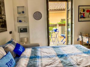 a bedroom with a bed and a clock on the wall at Porta 1 in Luino +20 photos