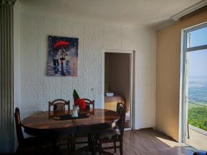a dining room with a table and a picture on the wall at Abramichi Guest House in Sighnaghi