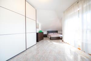 a bedroom with a bed and a large closet at Appartamento Smeraldo Mare in Marina di Massa