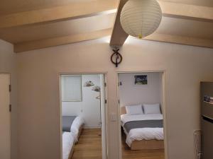 a bedroom with two beds and a ceiling at Hello Stay & Hangang Park, 5 min walk from Konkuk University, Seongsu, Jayang Subway Stations & Licensed Accommodation in Seoul