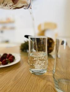 a glass of water is sitting on a table at Fortezzino in Rethymno
