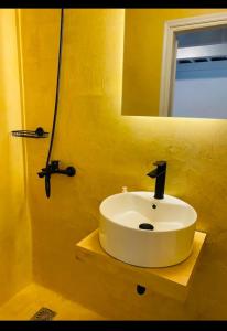 a bathroom with a white sink and a mirror at Fortezzino in Rethymno +19 photos