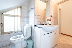 a white bathroom with a sink and a toilet at Appartamento Smeraldo Mare in Marina di Massa +28 photos