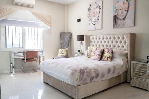 a bedroom with a large bed and a desk at Villa El Padrino in Callao Salvaje +39 photos