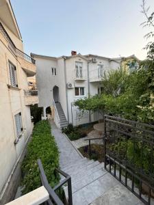 a stairway leading up to a row of buildings at Apartments Slavica Jovanovic in Sveti Stefan