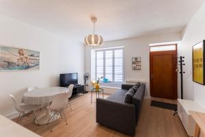 a living room with a couch and a table at Colmar City Center - Modern Studio COCOON - BookingAlsace in Colmar
