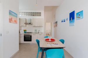 a kitchen and dining room with a table and chairs at Salento D'Amare - Salento Selection in Torre Chianca +17 photos