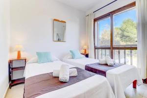 two beds in a room with a large window at Villa Mar Egos by Villa Plus in Cacla D'or +14 photos