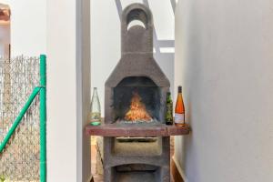 a stone fireplace with two bottles of alcohol on it at Villa Mar Egos by Villa Plus in Cacla D'or